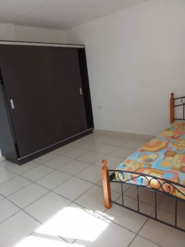 Contemporary bedroom with wardrobe tile floor and natural light Villa Lucre Panama rental