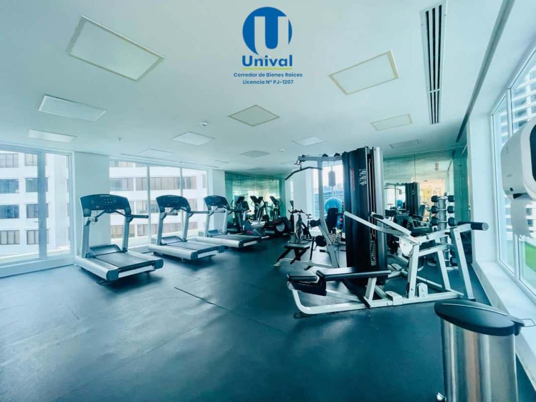 Modern rooftop swimming pool with lounge chairs overlooking Panama City skyline