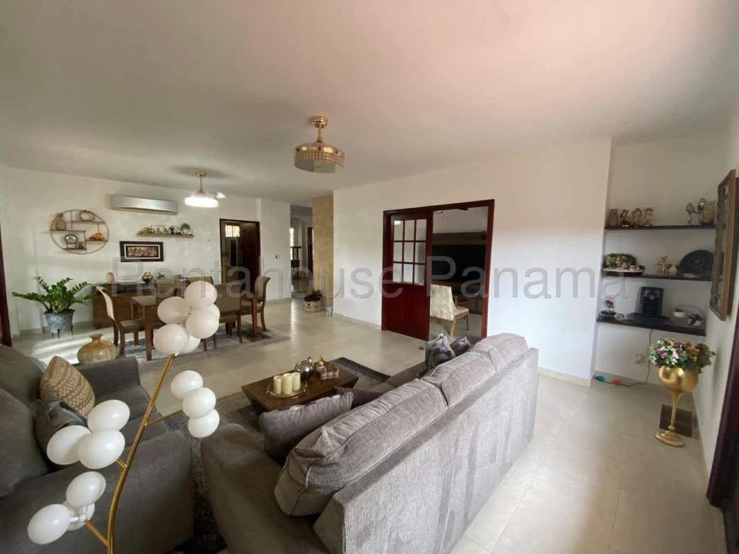 Bright home office space with large window, desk, bookshelves in Villa Valencia Costa Sur Panama