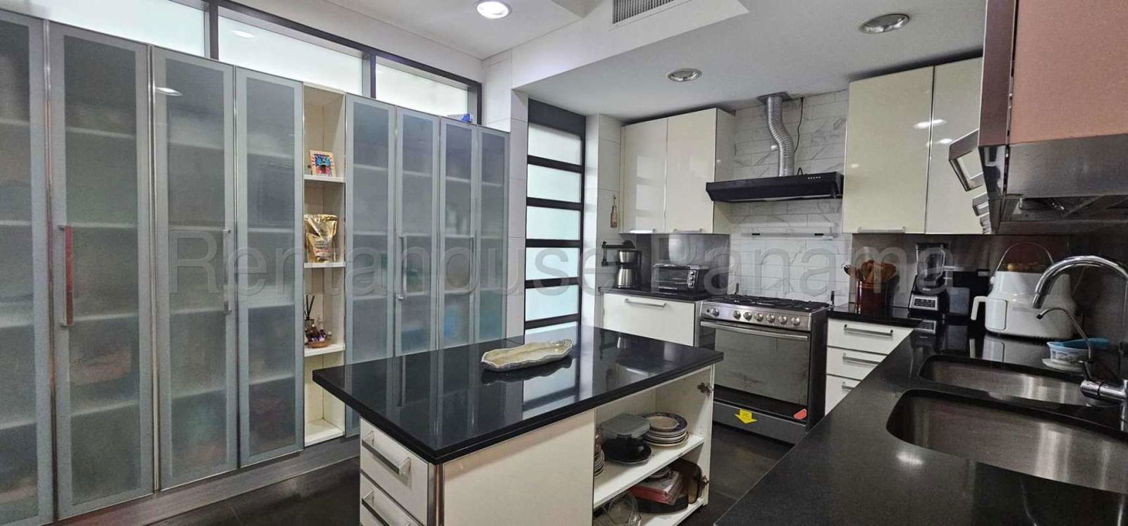 Contemporary kitchen with island, granite countertops and stainless appliances at Pacific Point Punta Pacifica