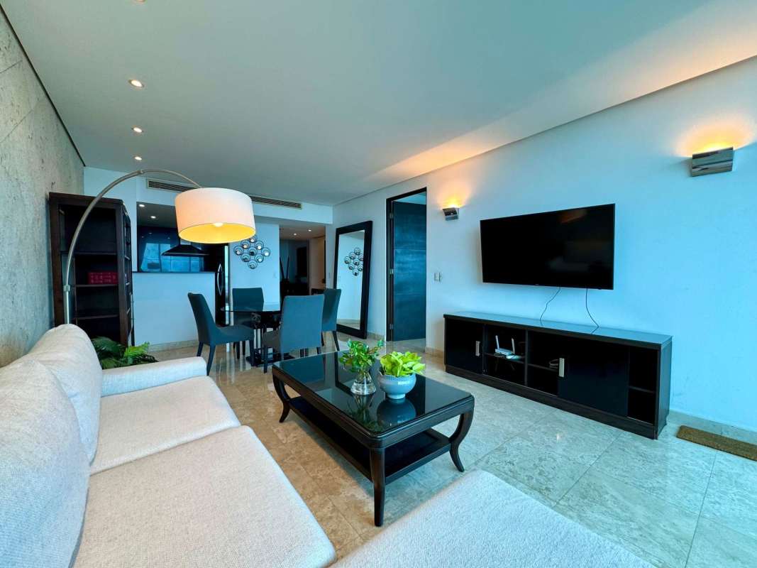 Contemporary kitchen with granite countertops, stainless steel appliances, wood cabinetry in PH Sky Panama