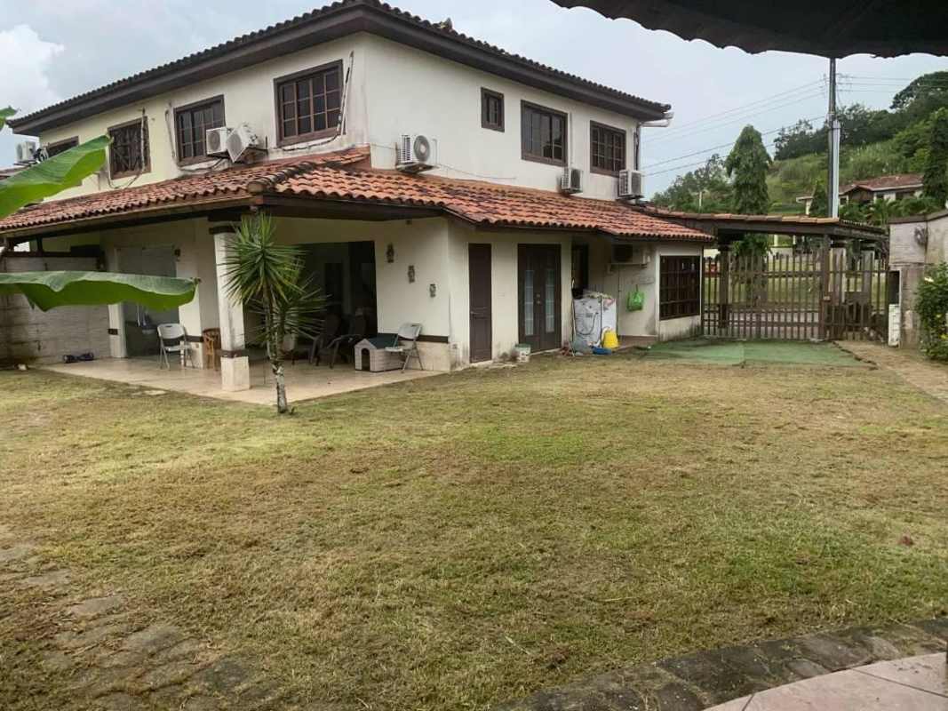 Exterior two-level Mediterranean style house with tile roof at Mirador del Lago Tocumen Panama
