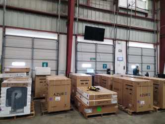 View inside industrial warehouse bays with overhead lighting in Panama Pacifico Park