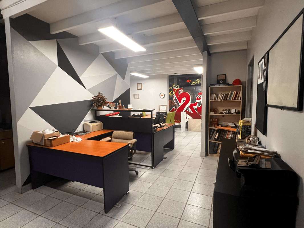 Office room with multiple desks and wall shelving commercial property Llano Bonito