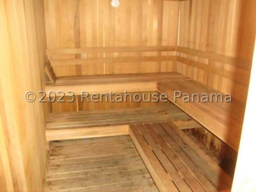 Spacious kitchen with granite countertops and wood cabinetry in Bahia del Golf Coco del Mar Panama City