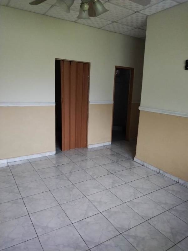 Bedroom with ceiling fan, tiled floor, folding door in Posada del Roble Panama
