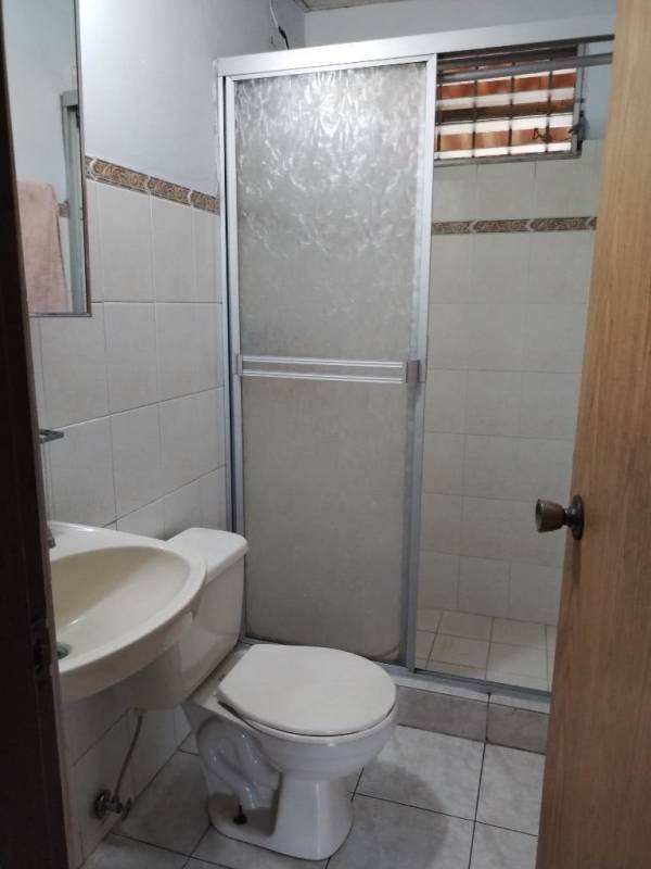 Exterior view of single-story house with wrought iron gate covered carport Posada del Roble Panama