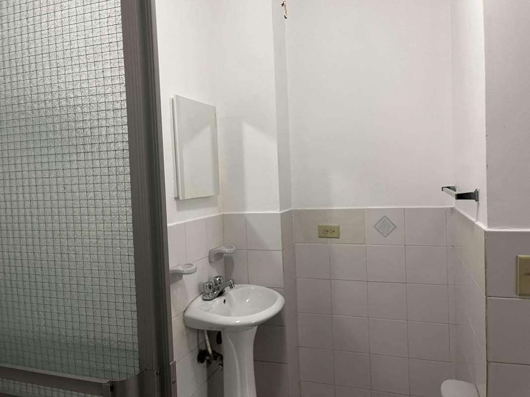 Bathroom tiled with sink shower frosted door Betania Panama apartment sale