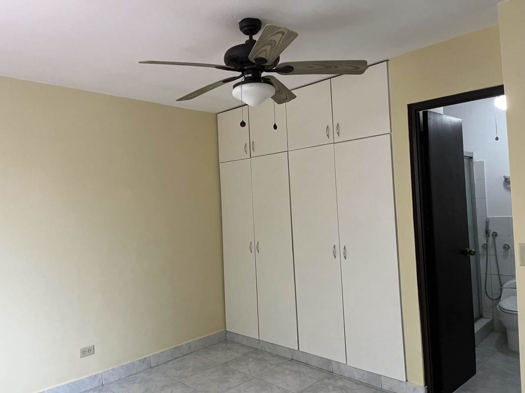 Bedroom featuring ceiling fan wardrobe and ensuite bathroom Betania apartment Panama City