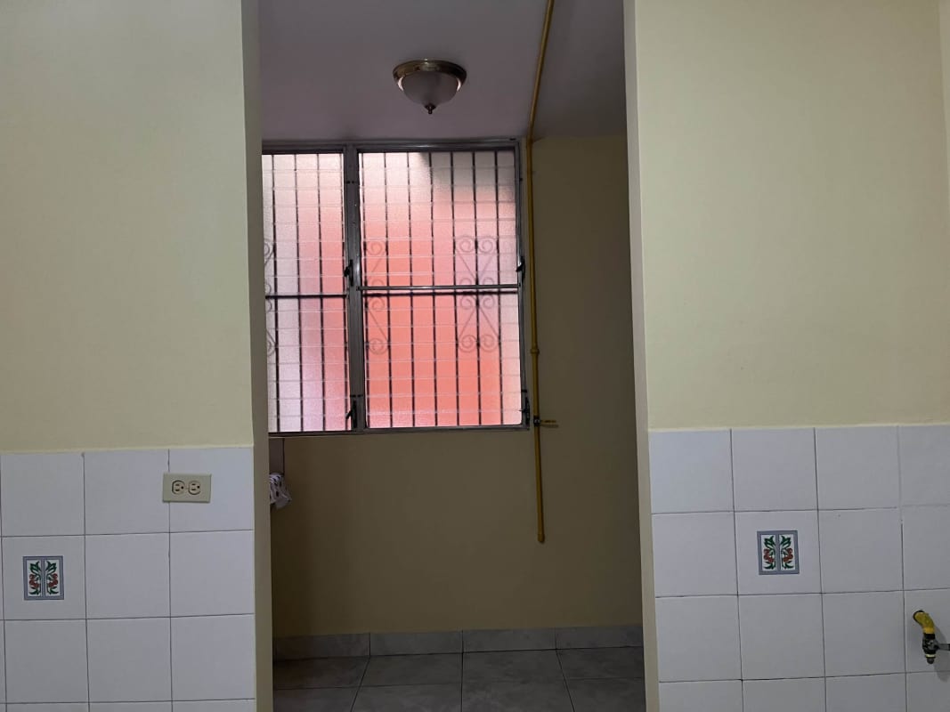 Compact kitchen double sink white cabinets in apartment Betania Panama