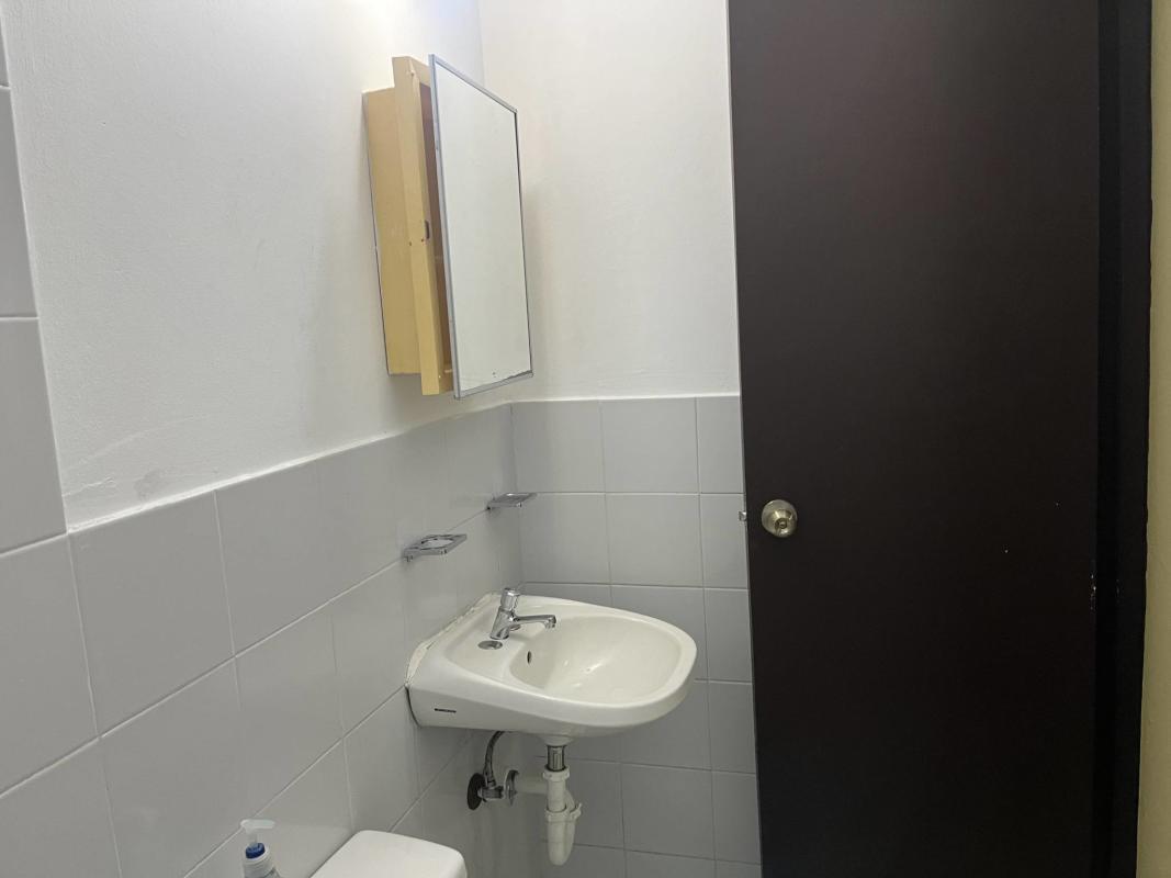 Simple tiled kitchen space with metal grill window gas line Betania apartment Panama