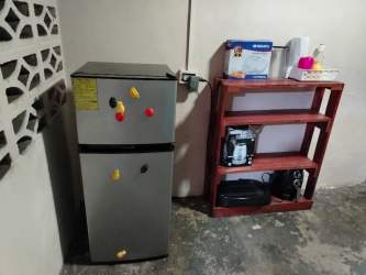 Basic furnished bedroom with closet, beds, fan, barred window in Veraguas Panama