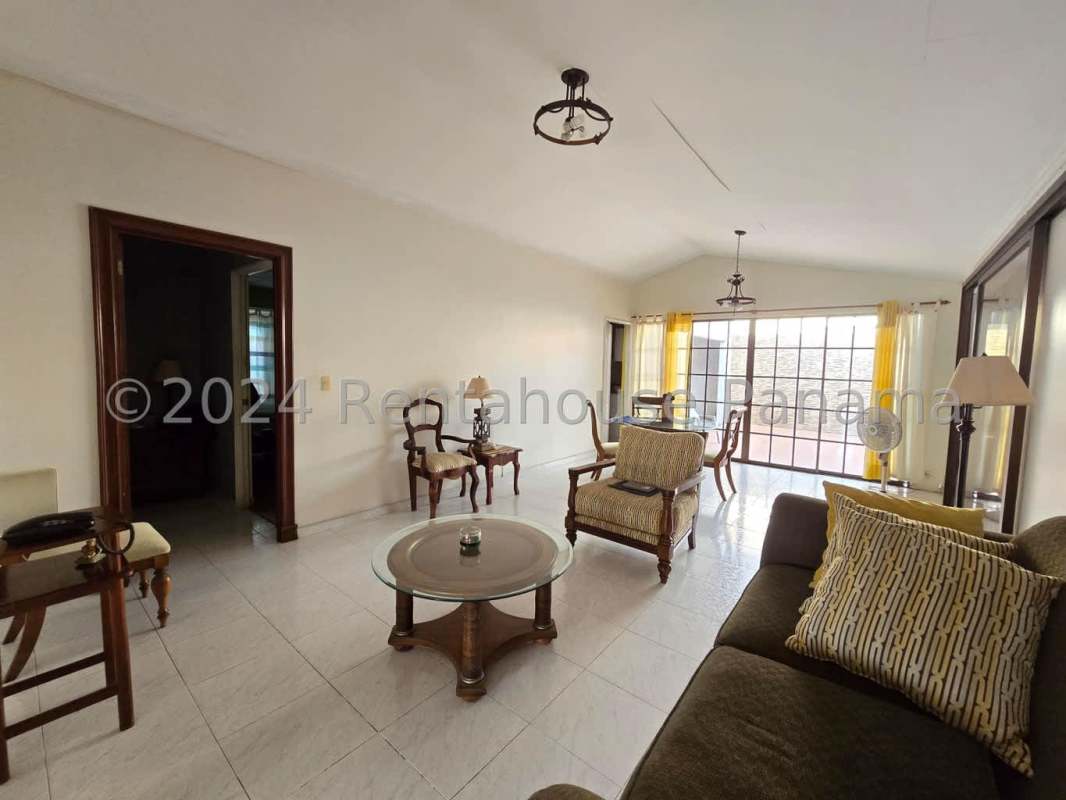 Interior hallway with orange wall, mounted TV, ceramic floor tile in Brisas del Golf Panama