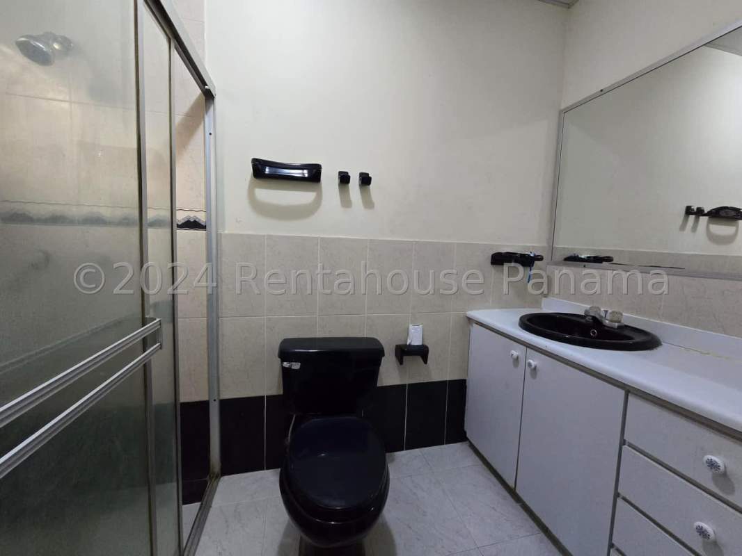 Bathroom with glass shower black fixtures large mirror Brisas del Golf Panama