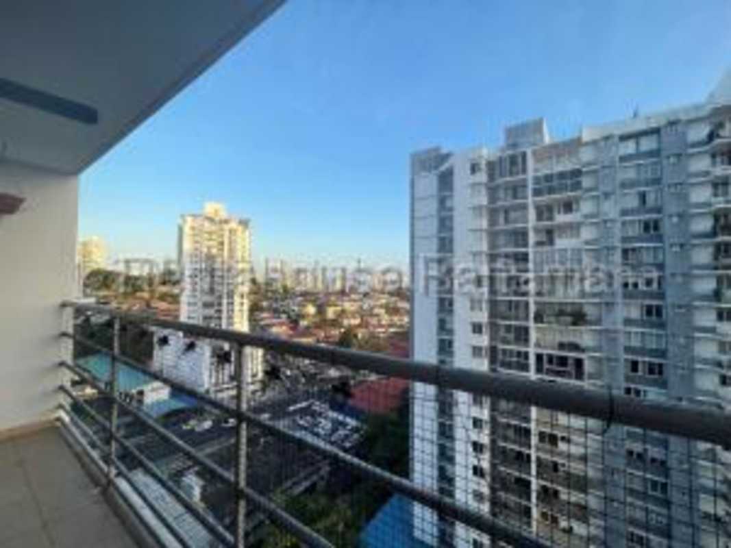 Swimming pool with lounge chairs, playground, and palm trees at Cosmopolitan Tower Panama