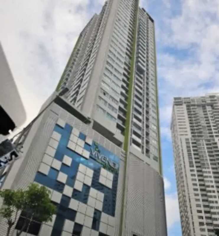 Bright living room with sliding doors to balcony and city view at PH Vivendi Green Panama City