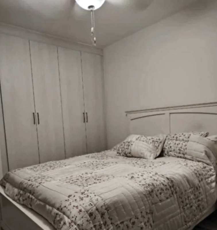 Kitchen with stainless refrigerator, stove, microwave, and wood cabinetry in PH Vivendi Green Edison Park Panama