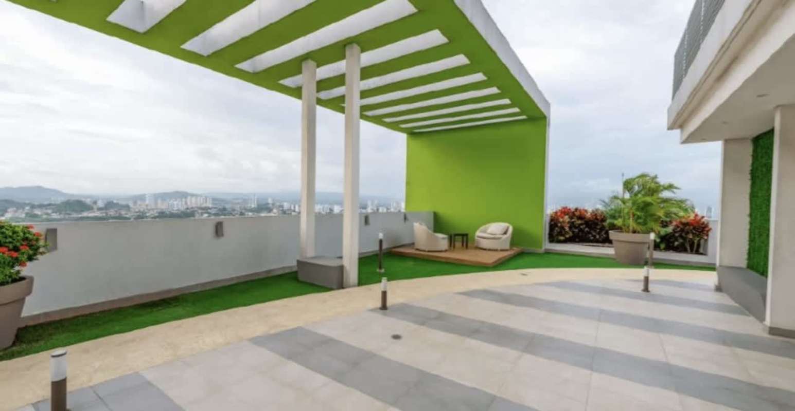 Safe colorful children's play area with slides and swings on rooftop social area PH Vivendi Green Edison Park Panama