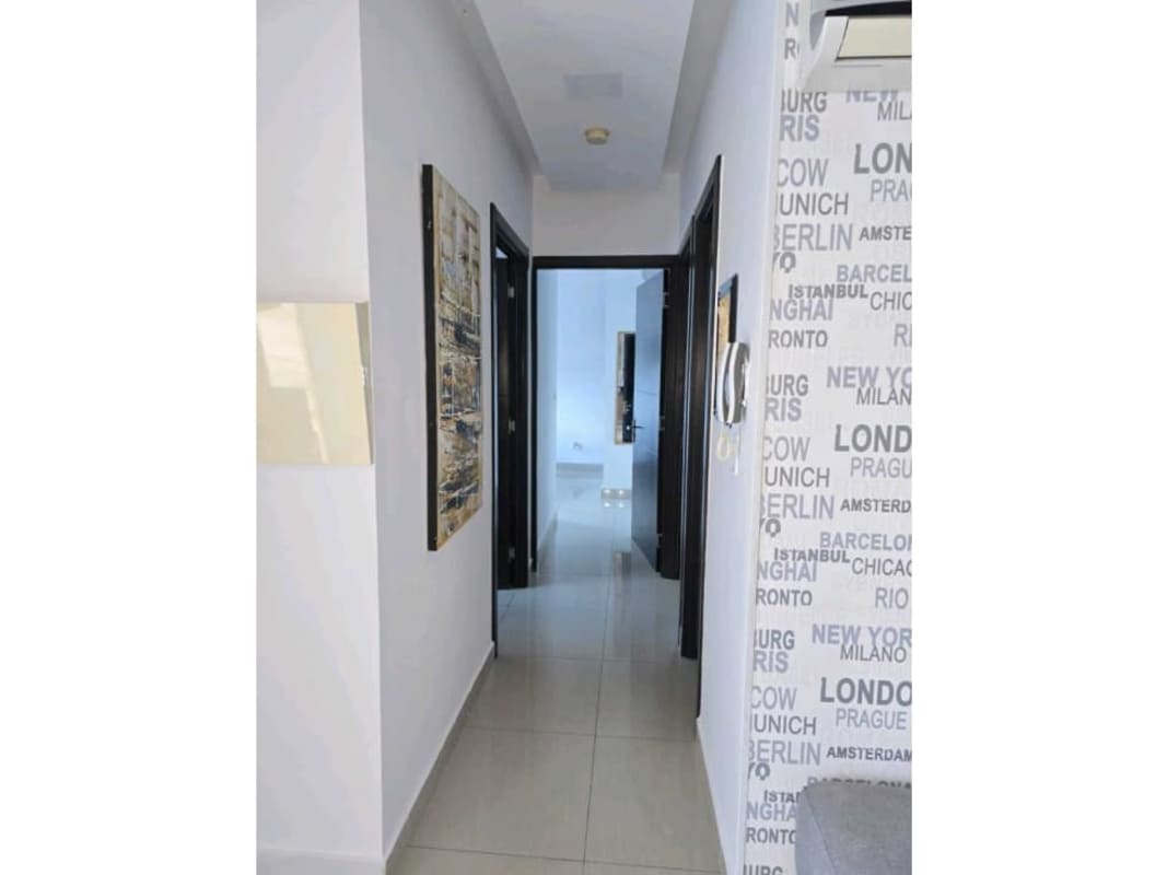 Bright hallway with glossy tile and city name wallpaper in PH Diamond San Francisco Panama