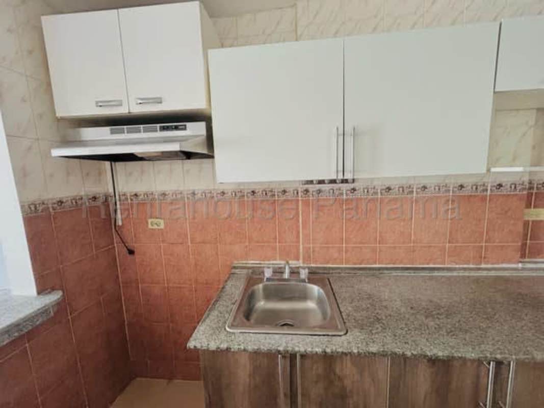 Pink mid-rise apartment with balconies exterior PH Avenida Pulida Panama