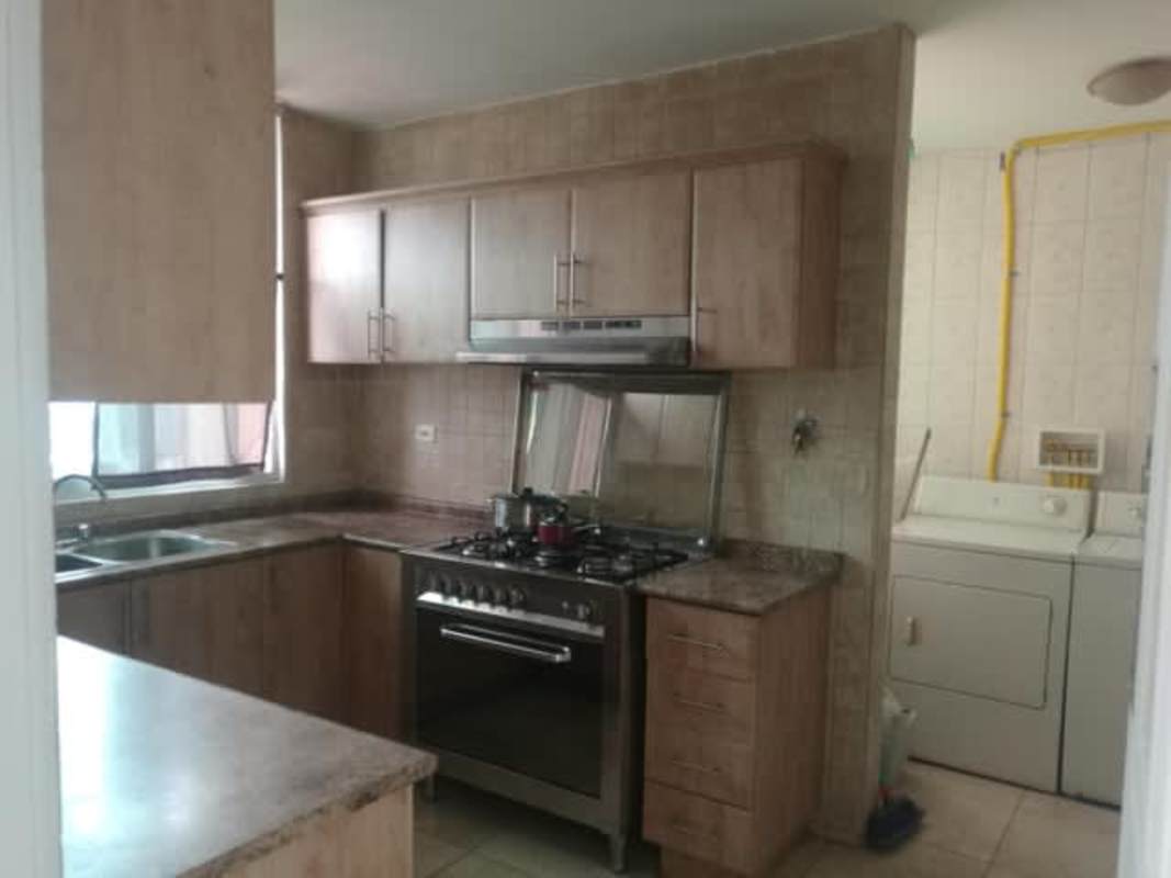 Contemporary kitchen with granite-style counters, cabinets and appliances at PH Porto Fino Panama