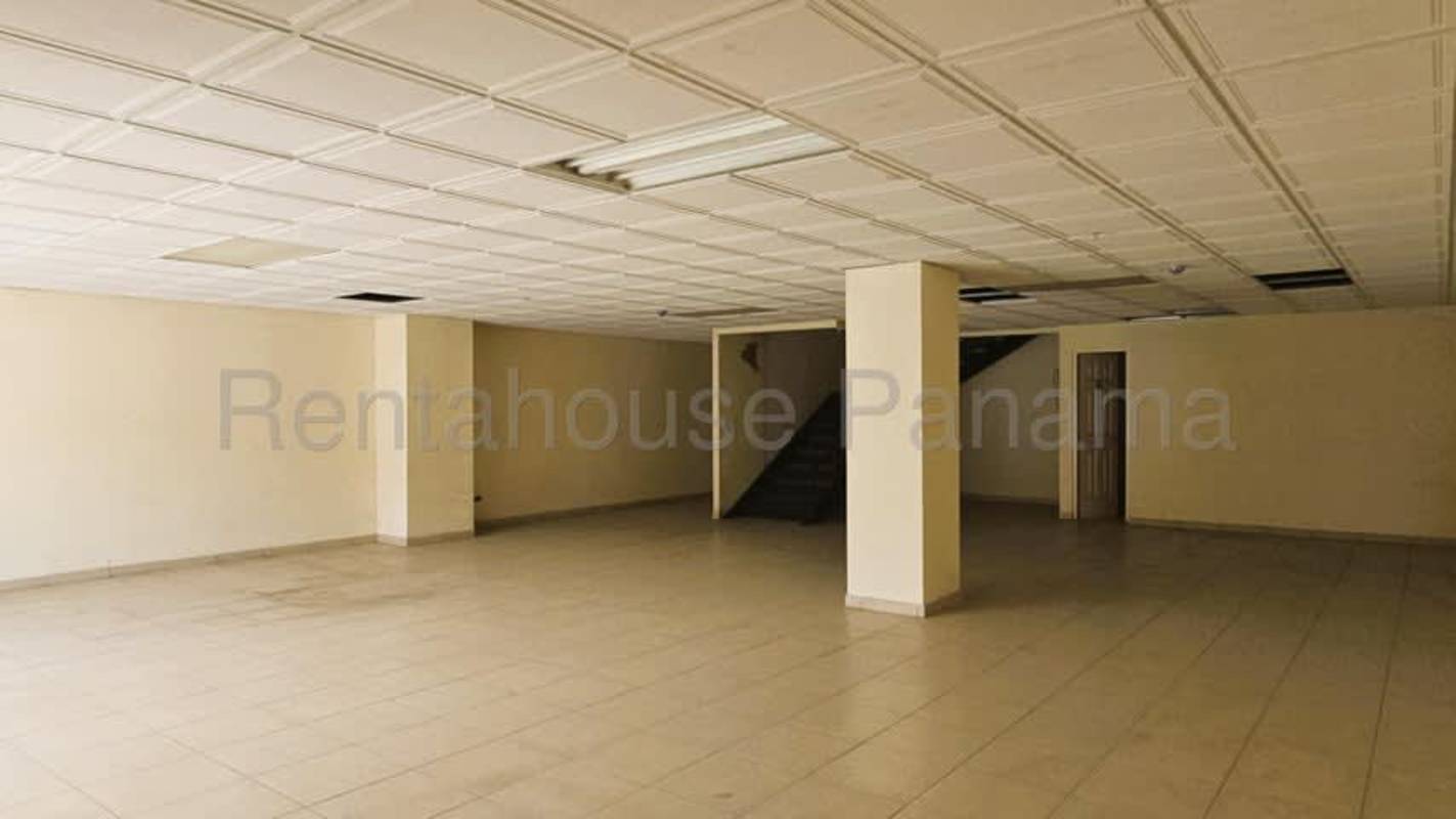 Ground floor commercial showroom space with tiled floors, columns and staircase in warehouse for rent Pacora Panama