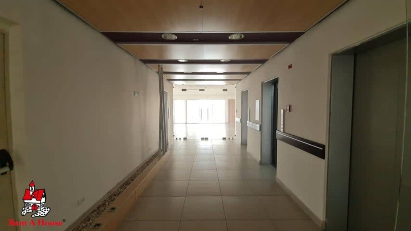 Modern corridor lobby with elevators and natural light in PH Business Tower