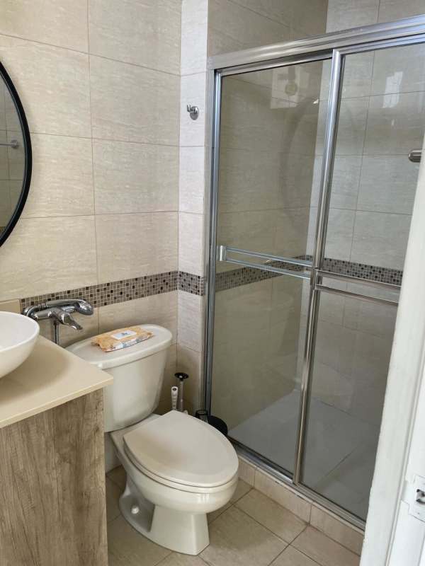 Bathroom with glass-enclosed shower, vessel sink, beige tiles in PH San Francisco Bay Tower 300 Panama