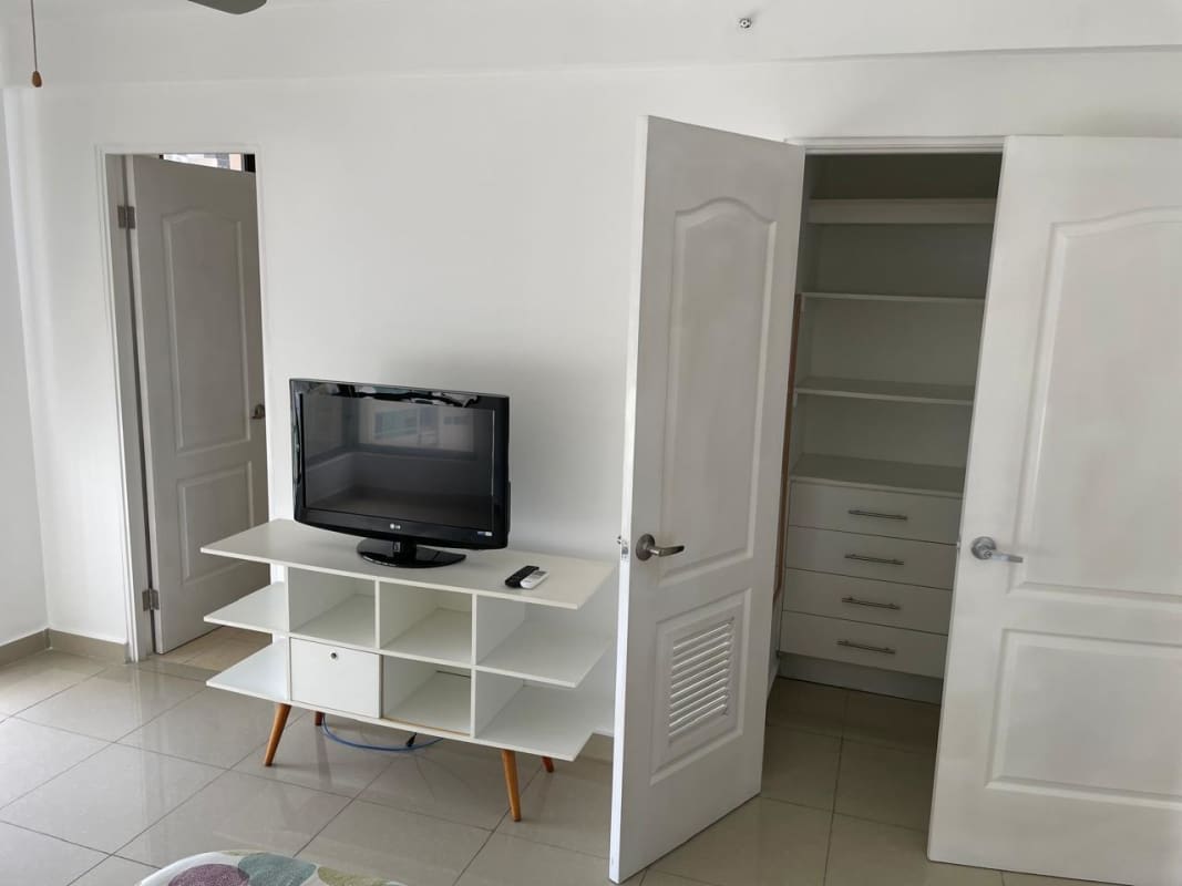 Bedroom with built-in closet shelving, TV stand, porcelain flooring in PH San Francisco Bay Tower 300 Panama