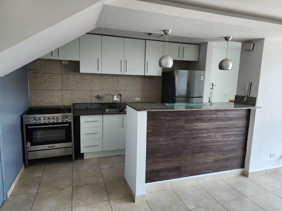 Kitchen with granite countertops, white cabinets, tiled backsplash PH Torres del Crisol II Panama El Crisol