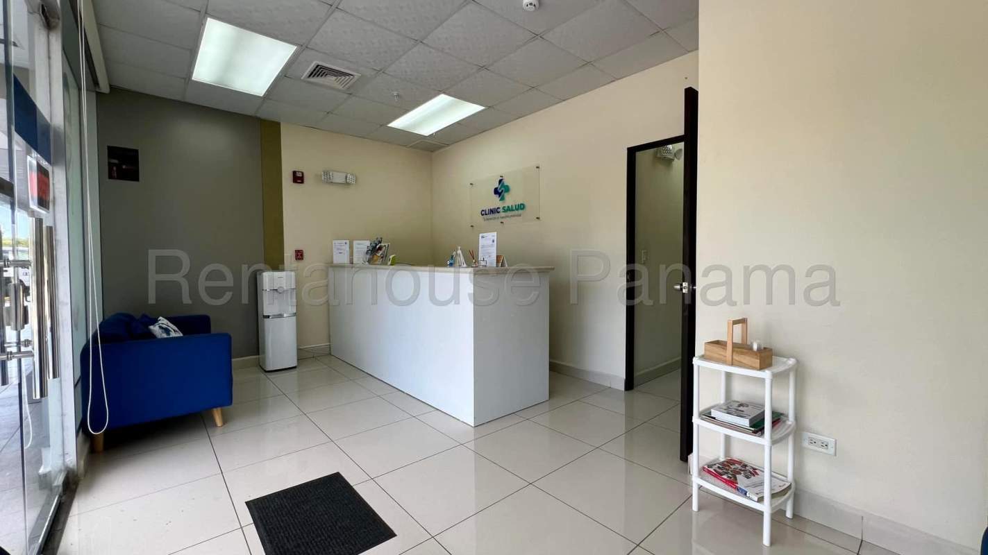 Modern clinic reception with blue sofa and glass entrance in commercial medical property for sale Panama