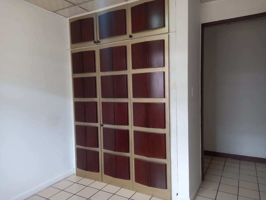 Bedroom with built-in closet and window in Condado del Rey townhouse Panama City