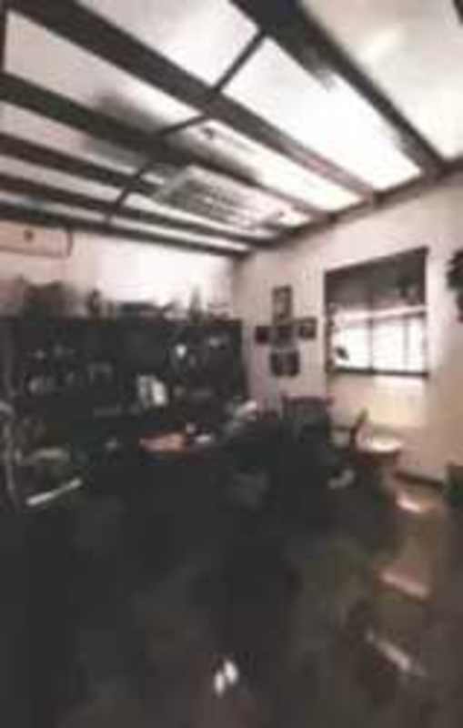 Traditional office interior with beamed ceiling and large window within commercial warehouse Rio Abajo