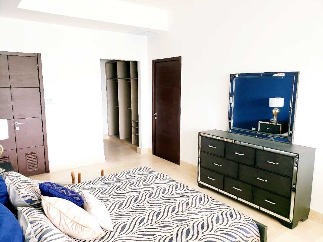 Modern bedroom with zebra pattern bedding, walk-in closet, wood doors, in Grand Tower Punta Pacifica Panama
