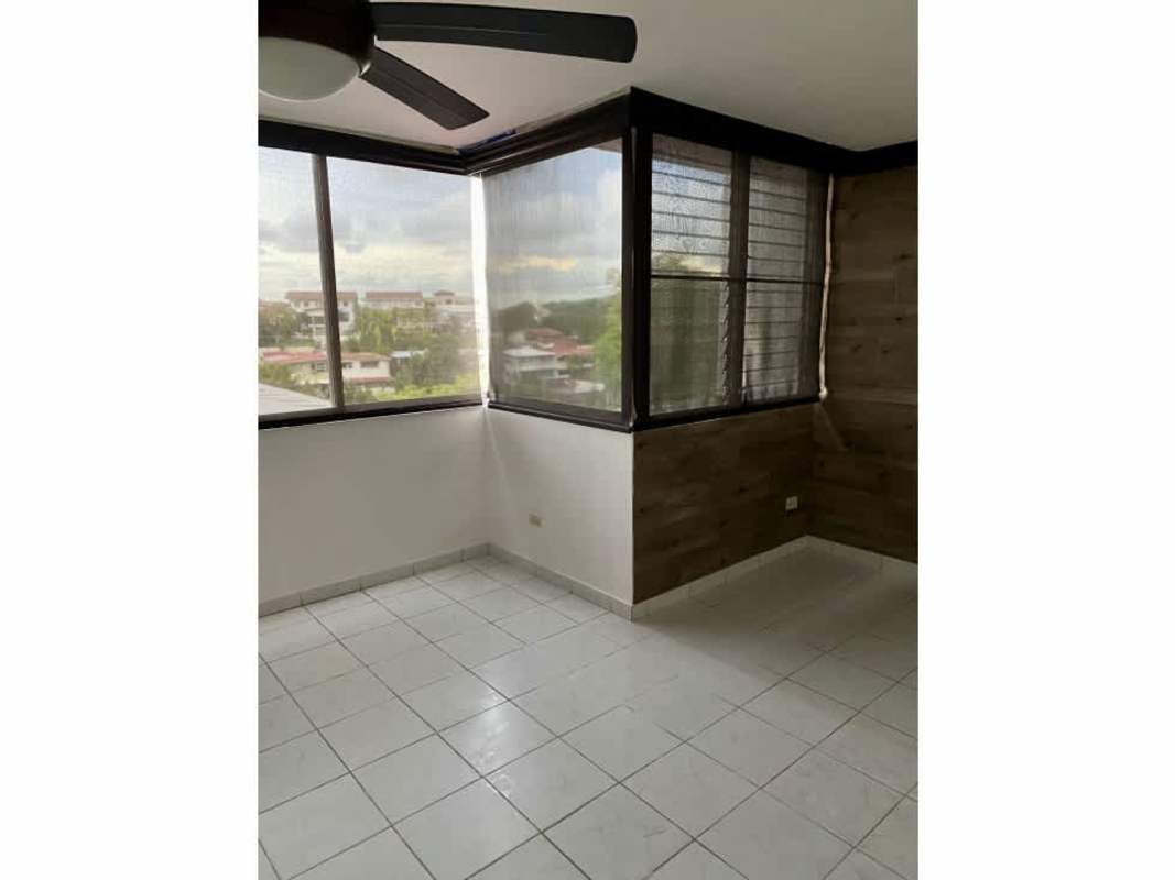 Bathroom with glass door shower, white tiled walls and window