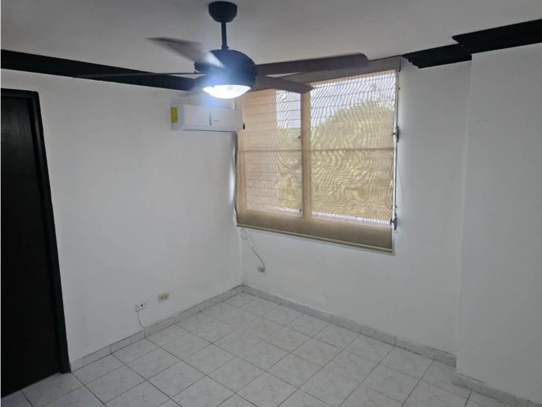 Empty bedroom with ceiling fan, AC unit, tiled floors, window view