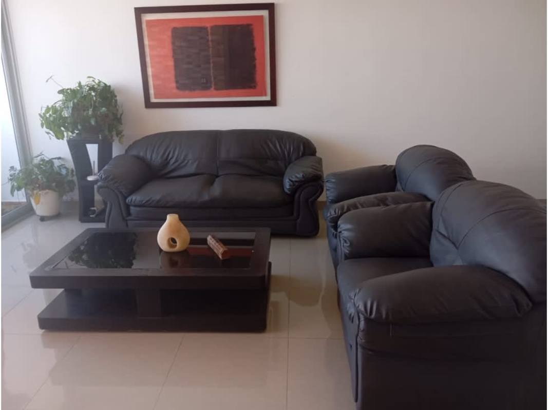 Contemporary living room with black leather sofas, city skyline view, PH Infinity Tower Panama