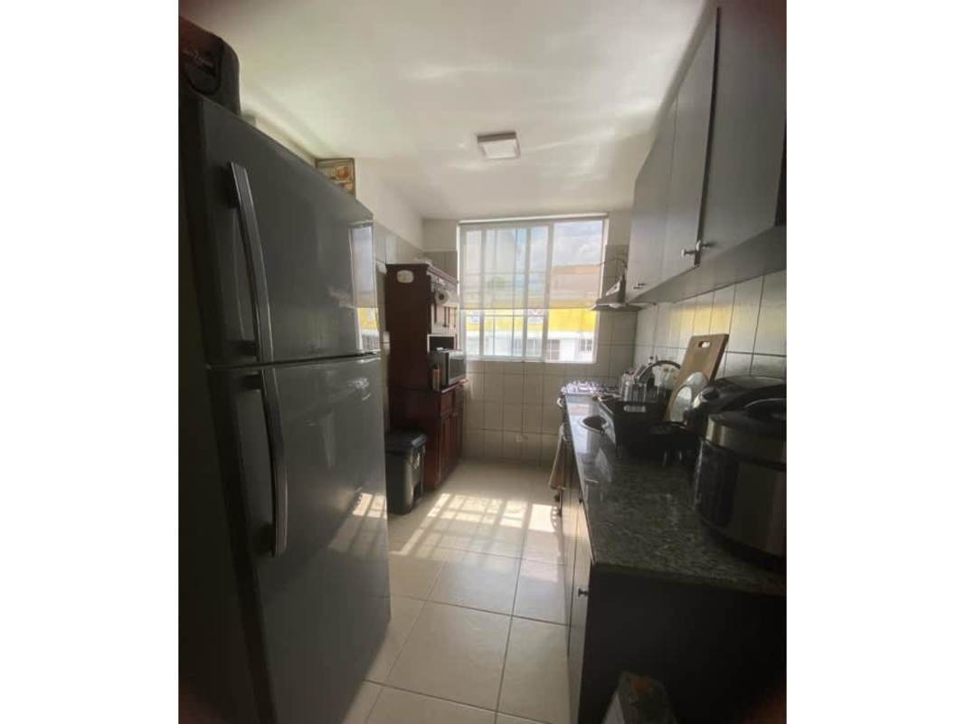 Kitchen with granite countertops, dark cabinets, gas stove, and large window PH Mystic Hills Dorasol Panama