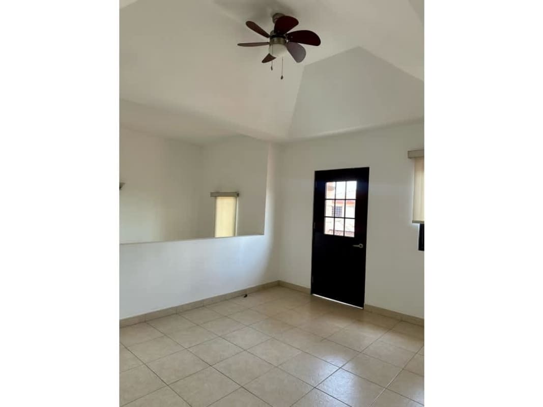 Two-story house with balcony, tile roof, garden and driveway at PH Versalles Costa Sur Panama City