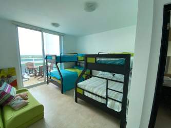 Modern L-shaped kitchen with wood cabinets stainless steel appliances Penthouse Playa Blanca