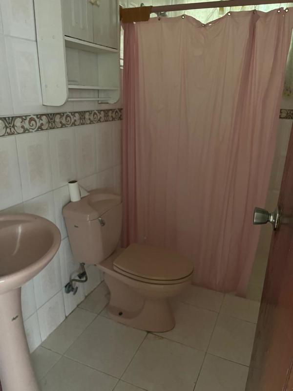 Tiled hallway with cream walls leading to entrance house in Pedregalito Juan Diaz Panama