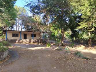 Rustic beach home exterior surrounded by mature trees large land lot Panama