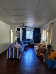 Living room with tiled floor AC ceiling fan window Playa Corona beach house