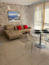 Contemporary living dining room with stone accent wall and large window PH Mosaic Panama Pacifico