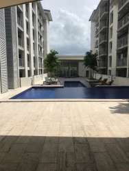 Swimming pool area with lounge chairs in PH Mosaic Panama Pacifico master community