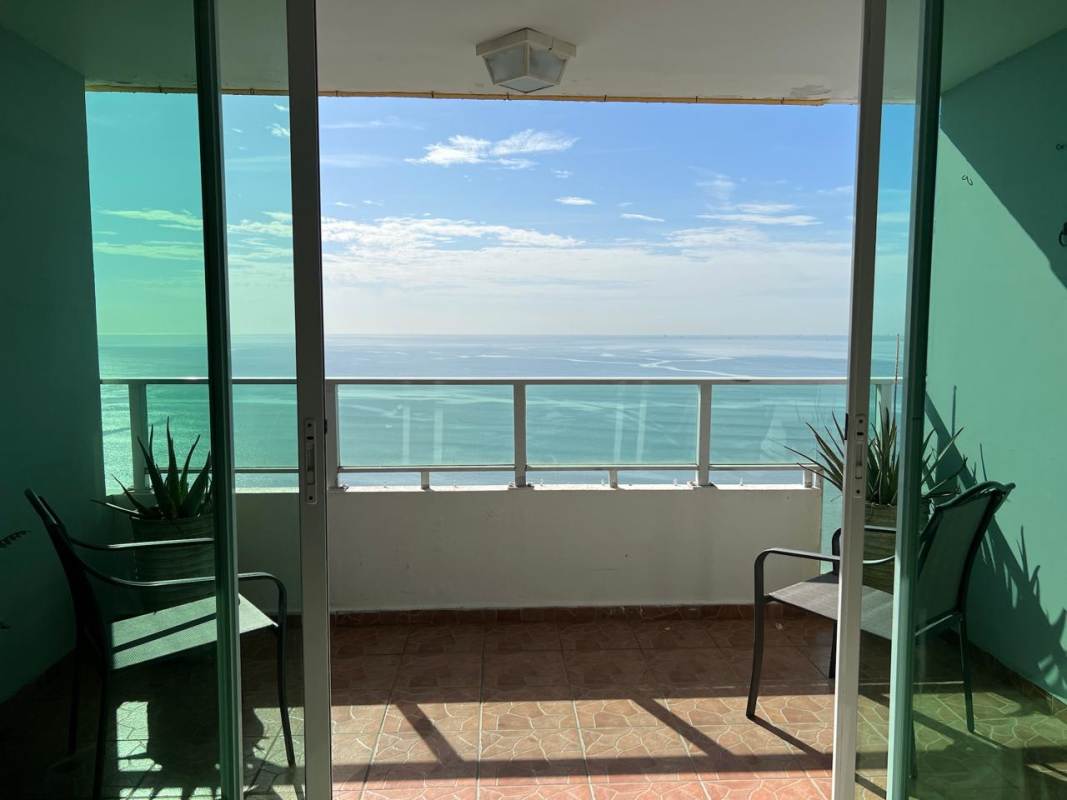 Bedroom featuring large ocean view window and AC in PH Terramar San Francisco Panama