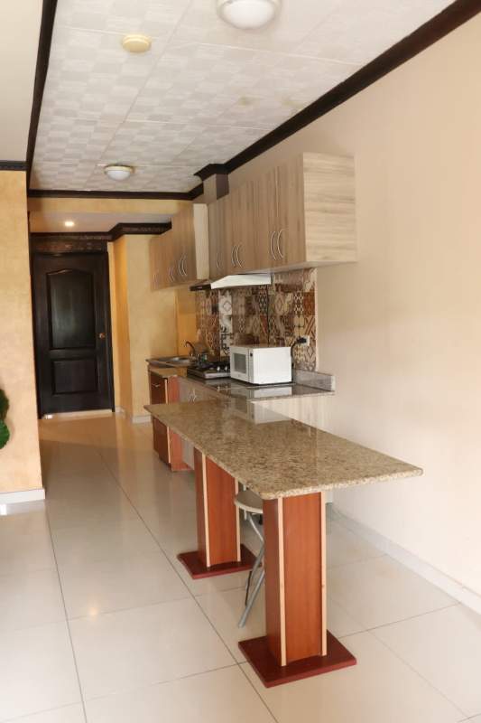 Fully equipped communal kitchen with granite countertops and appliances at Residencial Miraflores Bethania Panama