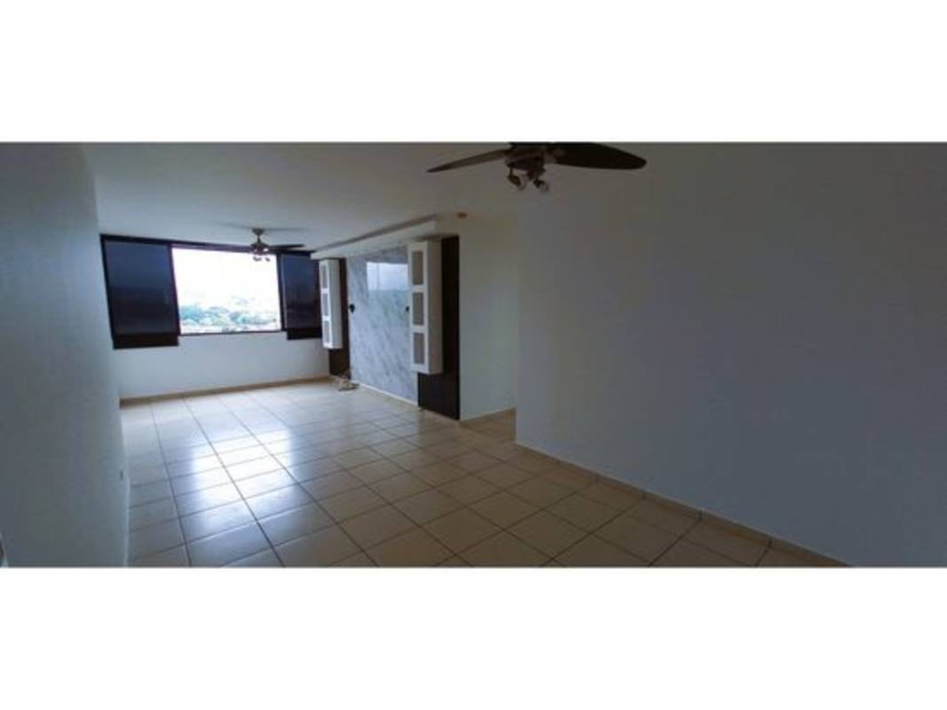 Large living area with marble accent wall and ceiling fans in PH La Locería Betania Panama