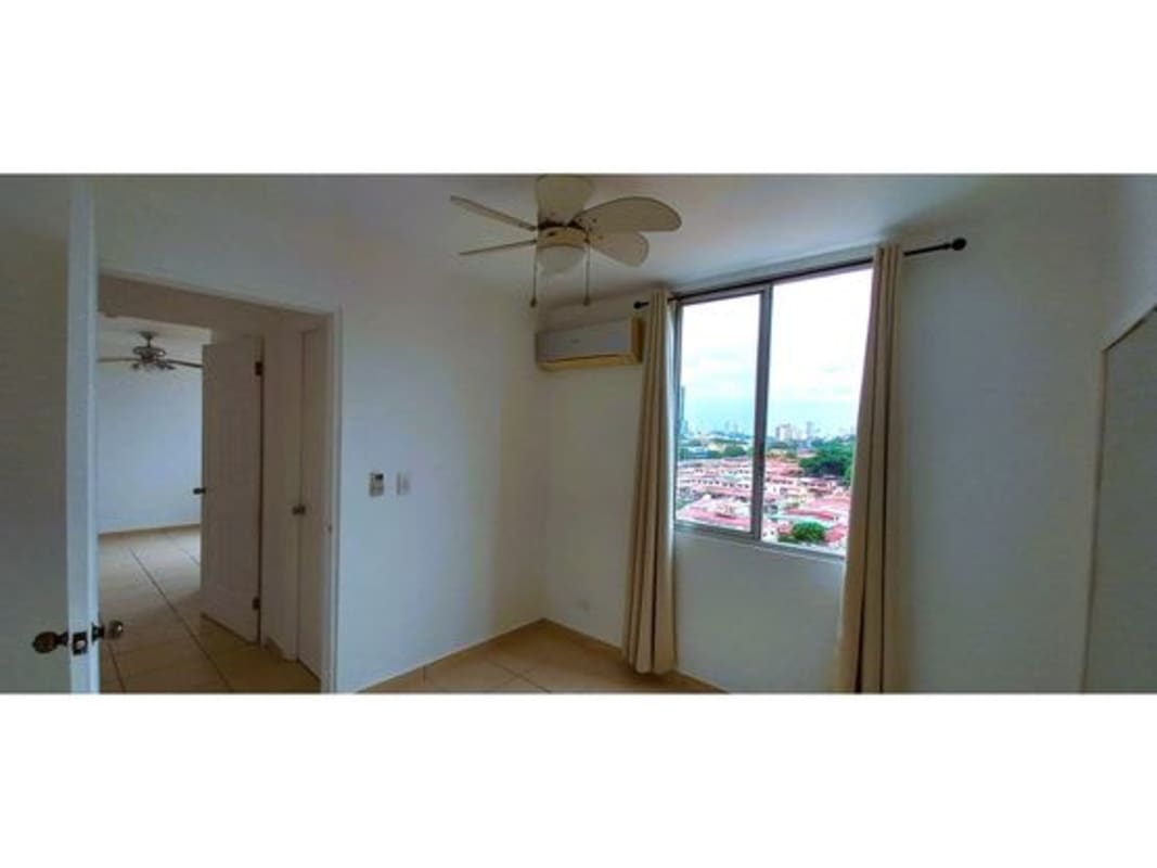 Bedroom with large window AC unit ceiling fan neutral decor in PH La Locería Betania Panama City