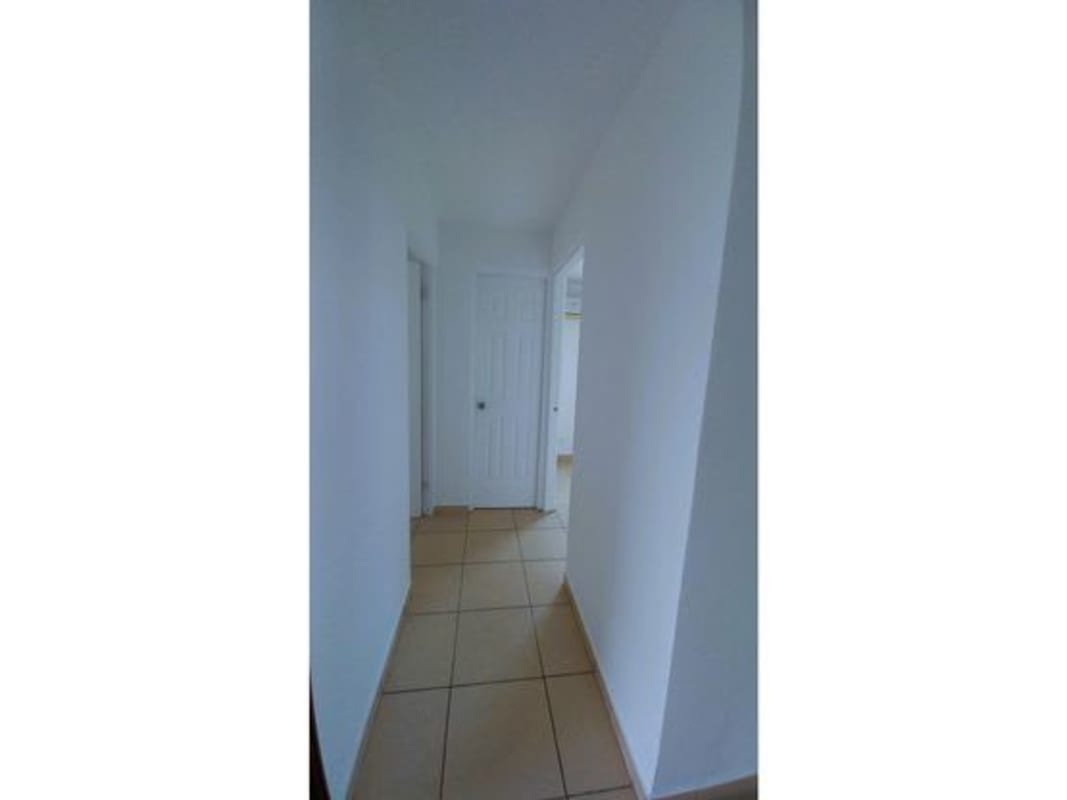 Bright hallway with tile flooring and recessed ceiling connecting rooms in PH La Locería Betania Panama